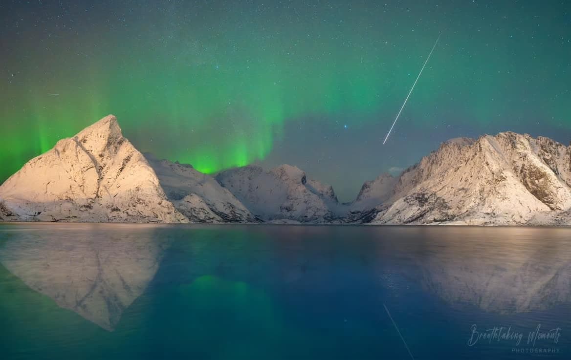 Aurora borealis with shooting star over Lofoten mountains